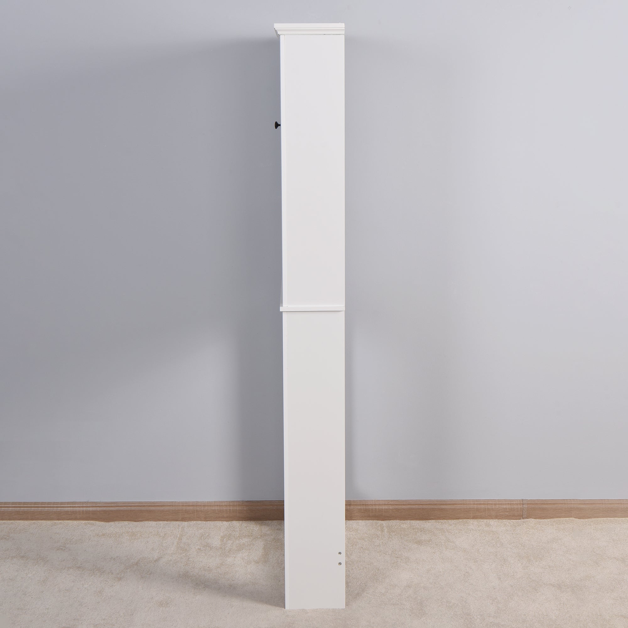 Side view of the white over-toilet storage cabinet